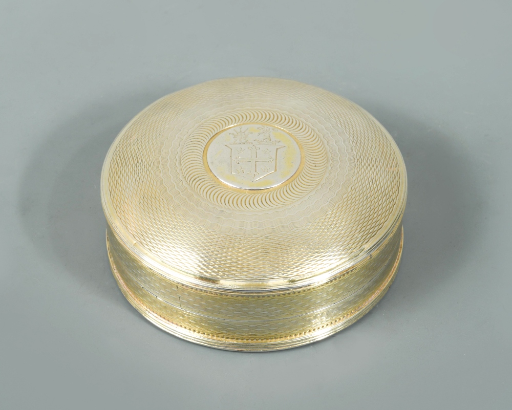 A George III silver gilt snuff box, maker unknown, Chester 1815, of circular form, engine turned all