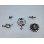 A collection of five 19th century paste set brooches, the first with an oval enamel portrait of a