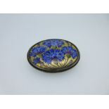 A Continental mid 20th century hand-enamelled brooch depicting cornflowers, the horizontal oval