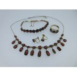 A garnet fringe necklace and matched suite of garnet jewellery, the necklace spectacle set to the