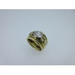 An 18ct gold hand made diamond ring in the style of Elizabeth Gage, the ring of solid concave form