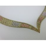 A 9ct tri-colour gold collar necklace, the front designed as twin graduated flexible plaques of