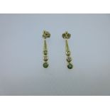 A pair of emerald and diamond set earpendants, each post headed by a 2mm gold bead and suspending