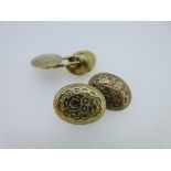 A pair of Victorian engraved 15ct gold double-ended cufflinks, each oval concave end with carved and