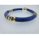 A blue hardstone bracelet, composed of four curved cylindrical hardstones, probably lapis lazuli, of