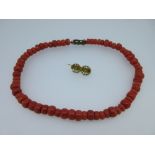A traditional Dutch red coral bead necklace and small Dutch brooch, the necklace composed of short