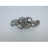 A mid 20th century diamond double clip brooch, the two asymmetrical but identical pieces of pierced,