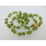 A peridot bead and bouton cultured pearl necklace, the polished flattened sphere peridots, 6mm