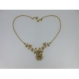 A diamond, seed pearl and chain link flower necklace, the articulated central section fashioned as a