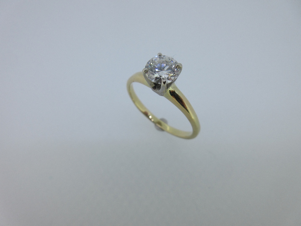 A single stone diamond ring, the round brilliant cut diamond, estimated weight 0.80ct, in a four
