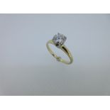 A single stone diamond ring, the round brilliant cut diamond, estimated weight 0.80ct, in a four