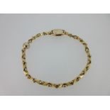 An Italian fancy link bracelet marked for 18ct gold, composed of close set geometric links held by