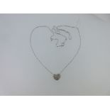 A diamond set heart shaped pendant and chain, the slightly domed heart pavé set with numerous