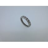 A full hoop diamond eternity ring, with nineteen round brilliant cut diamonds claw set in unmarked