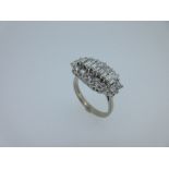 A 20th century diamond cluster ring set in 18ct white gold, the central row of five baguette cut