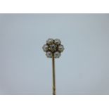 A pearl and diamond stick pin, designed as a flowerhead, the central crimp collet set old cut