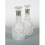 A pair of George V cut glass decanters with silver collars, by Garrard & Co, London 1925, of
