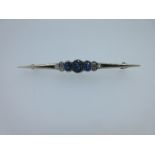 A sapphire and diamond nine stone bar brooch, the central section set with three graduating rub over