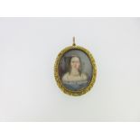 An early Victorian double-sided pendant with a portrait miniature front and hairwork back, the