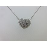 A diamond set heart shaped pendant and chain, the slightly domed heart pendant covered with pavé set