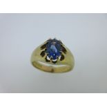 A Victorian single stone sapphire ring, the oval facetted sapphire claw set to split shoulders and