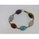 A bracelet set with six different hardstones, the oval cabochon stones, variously amethyst, grey