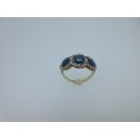 An Edwardian sapphire and diamond triple cluster ring, the three graduating oval facetted