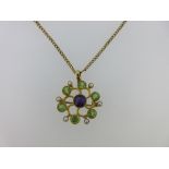 A Suffragette colour brooch / pendant with chain, designed as an open Catherine wheel with central
