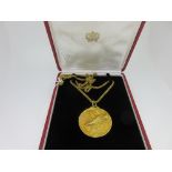 Cartier - An 18ct gold zodiac medallion and chain in the original case, the cast medallion