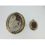 A Victorian garnet cabochon pendant and a similar period cameo brooch with classical scene, the oval