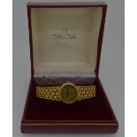 Omega - A lady's 18ct gold 'De Ville' wristwatch, circa 1975, the signed oval gold coloured textured