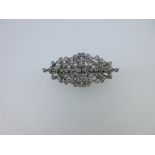A diamond double clip brooch, of book-matched pierced and foliate design and navette shaped outline,