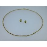 An 18ct gold fancy link chain together with a pair of 18ct gold peridot set earstuds, the chain of