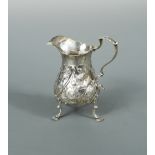 A George III silver cream jug with later decoration, possibly by William Skeen, London 1765, of