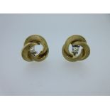 A pair of 18ct gold knot earstuds by Cropp & Farr, each a knot of three intersecting satin