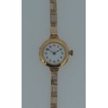 An unsigned 9ct gold lady's wristwatch, circa 1914, the circular white dial, 20mm diameter, with
