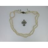 A two row cultured pearl necklace with sapphire and seed pearl clasp together with a seed pearl