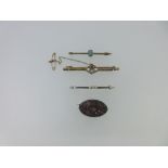 A collection of four brooches, the first a simple bar brooch of rectangular section peg set with