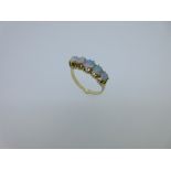 A five stone opal half hoop style ring, the five graduating round cabochon opals claw set to a solid