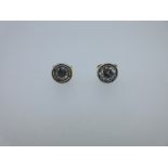 A pair of single stone diamond earstuds set in 18ct gold, each round brilliant cut diamond in an