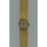 Omega - A lady's 18ct gold and diamond wristwatch, circa 1969, the signed circular champagne dial,