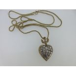 A diamond set St Esprit pendant on a gold foxtail link chain, the pendant heart pavé set to the