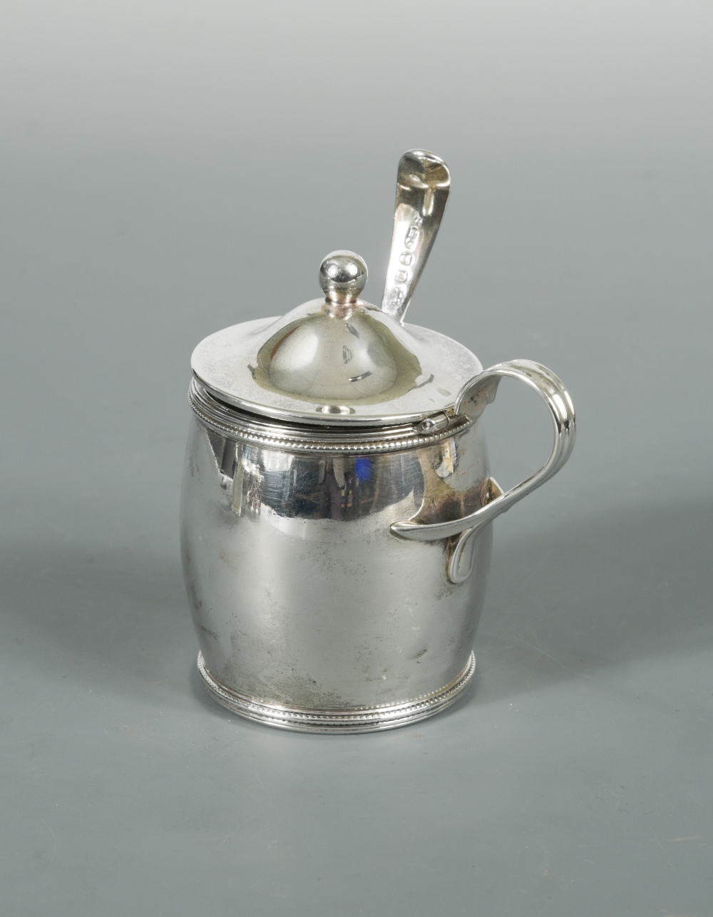 A George III silver barrel shaped mustard and spoon, by Michael Plummer, London 1795, with reed