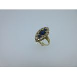 An 18ct gold sapphire and diamond navette shaped ring, with a vertical line of three graduated