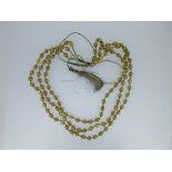 A three row necklace of lantern shaped beads that test for gold, each hollow round bead, 8.3mm