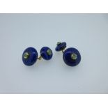 A pair of lapis lazuli and emerald cufflinks, each with one end a circular bouton of lapis lazuli