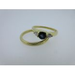 An 18ct gold sapphire and diamond three stone ring by Cellini and an 18ct gold wedding band, the