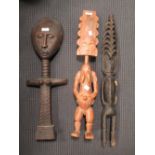 A Fante tribal carved wood doll and an Akuaba carved deity and another (3) All about 65cm high