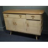 An Ercol elm sideboard, faded, 83 x 123 x 46cm