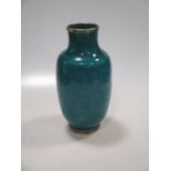 An Asian turquoise glazed vase with foliate decoration 22cm high